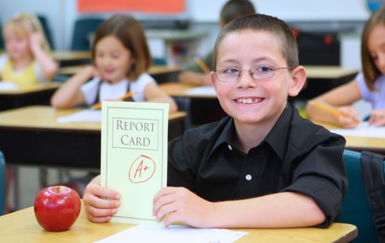  boy holding report card